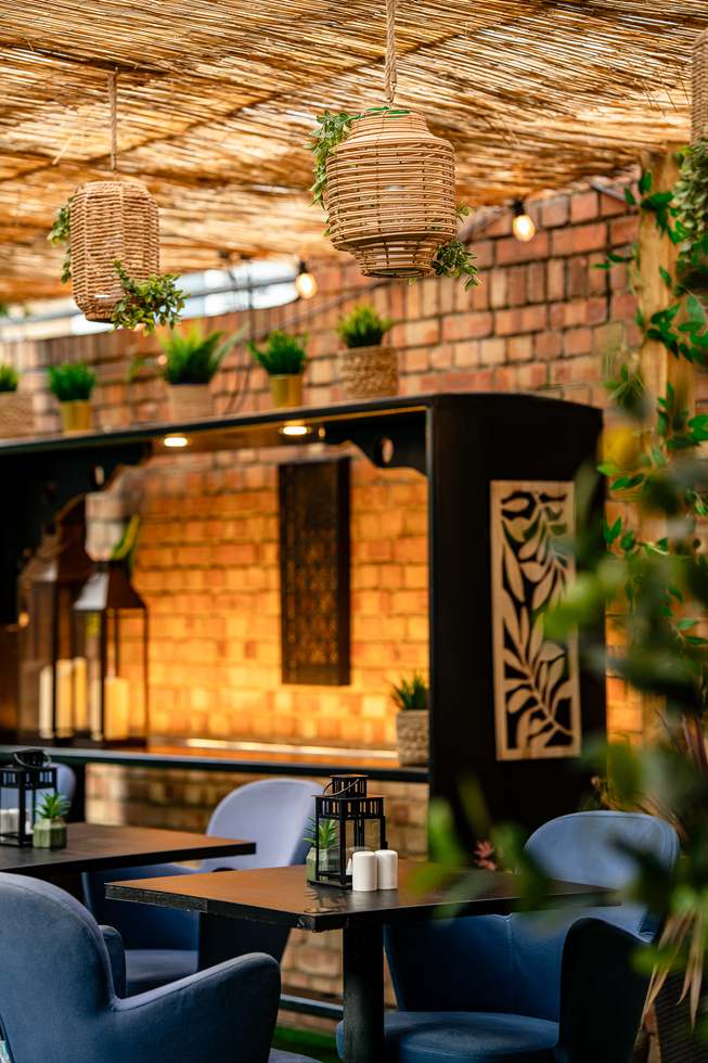 Covered terrace seating with rattan lanterns